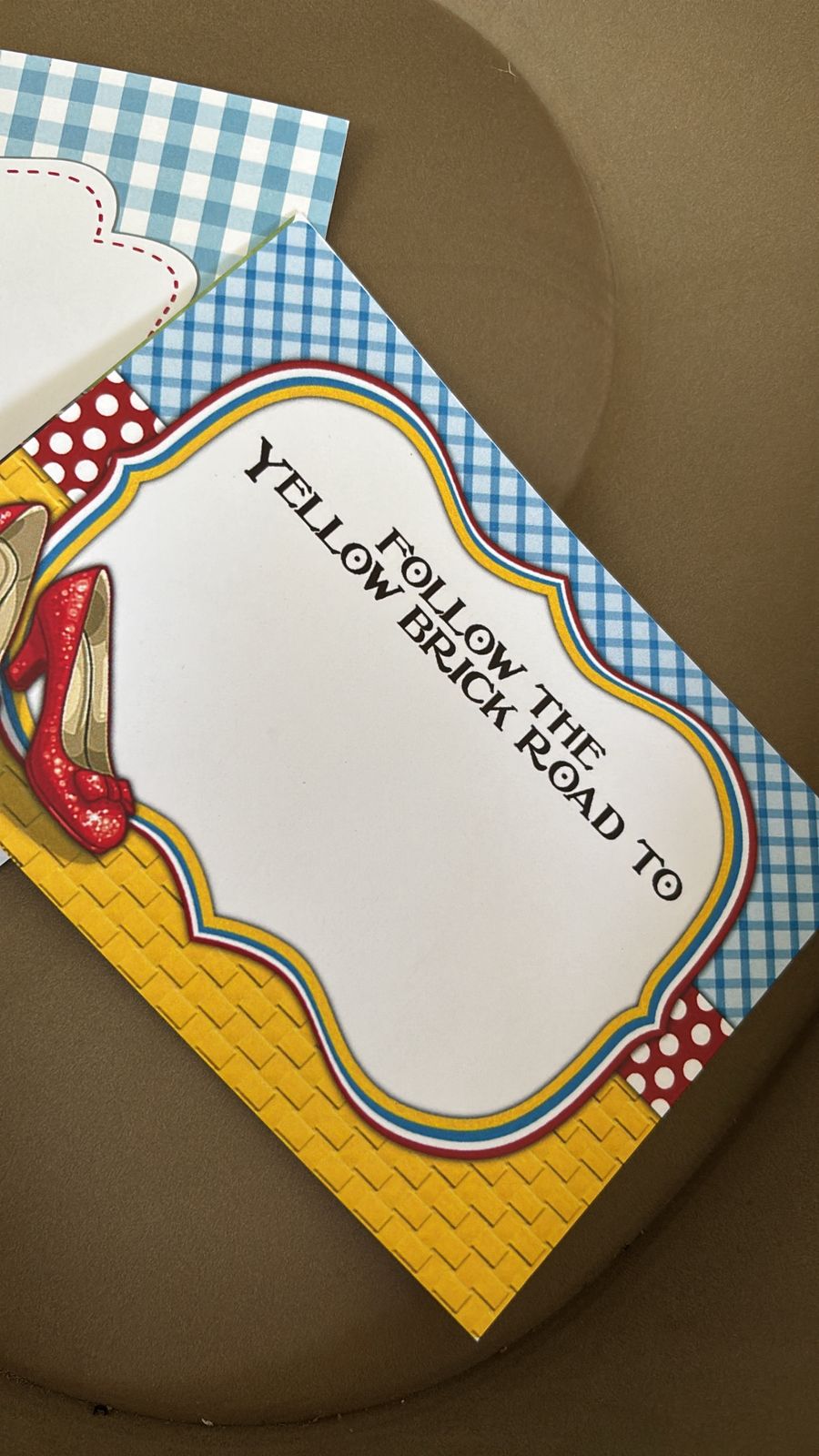 Wizard of Oz birthday invitation template featuring ruby slippers, Emerald City skyline, yellow brick road, rainbow, Toto, and storybook party details