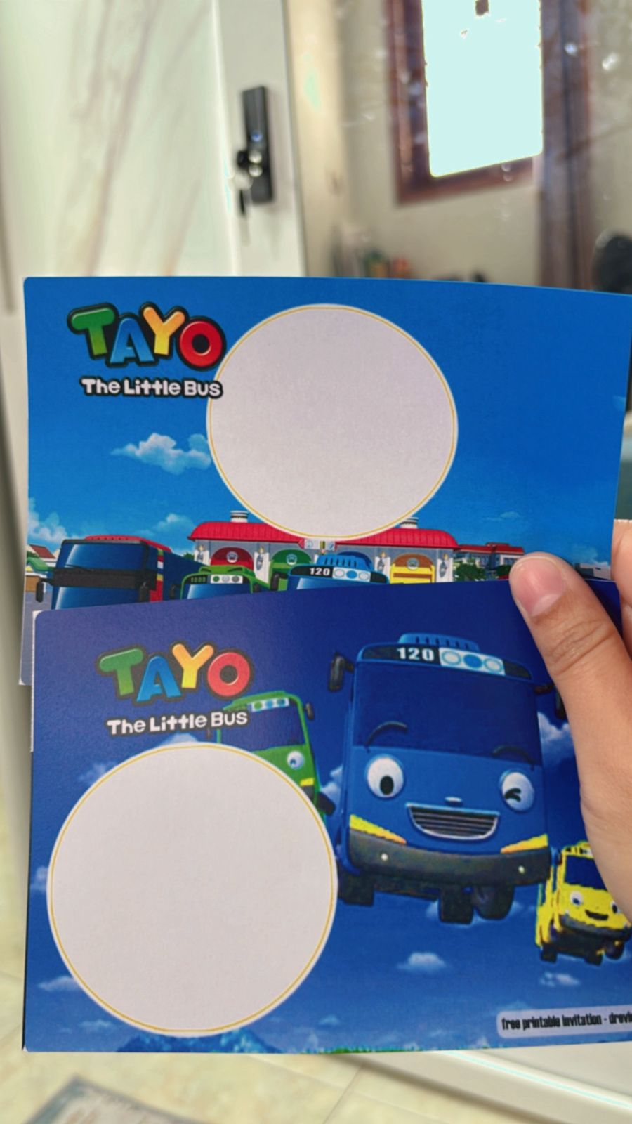 DIY Tayo birthday invitation showing cartoon buses driving on roads with signage, numbers and cheerful city theme

