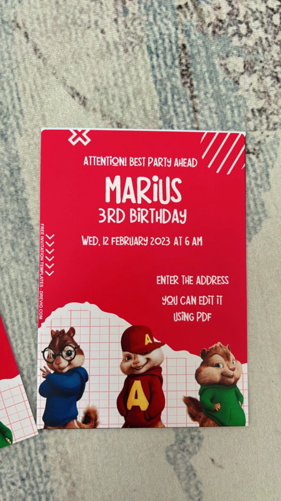 Alvin and the Chipmunks themed birthday invitation design with bold red background, cartoon Chipmunks centered, music notes floating around, playful confetti bursts, and party elements circling the layout