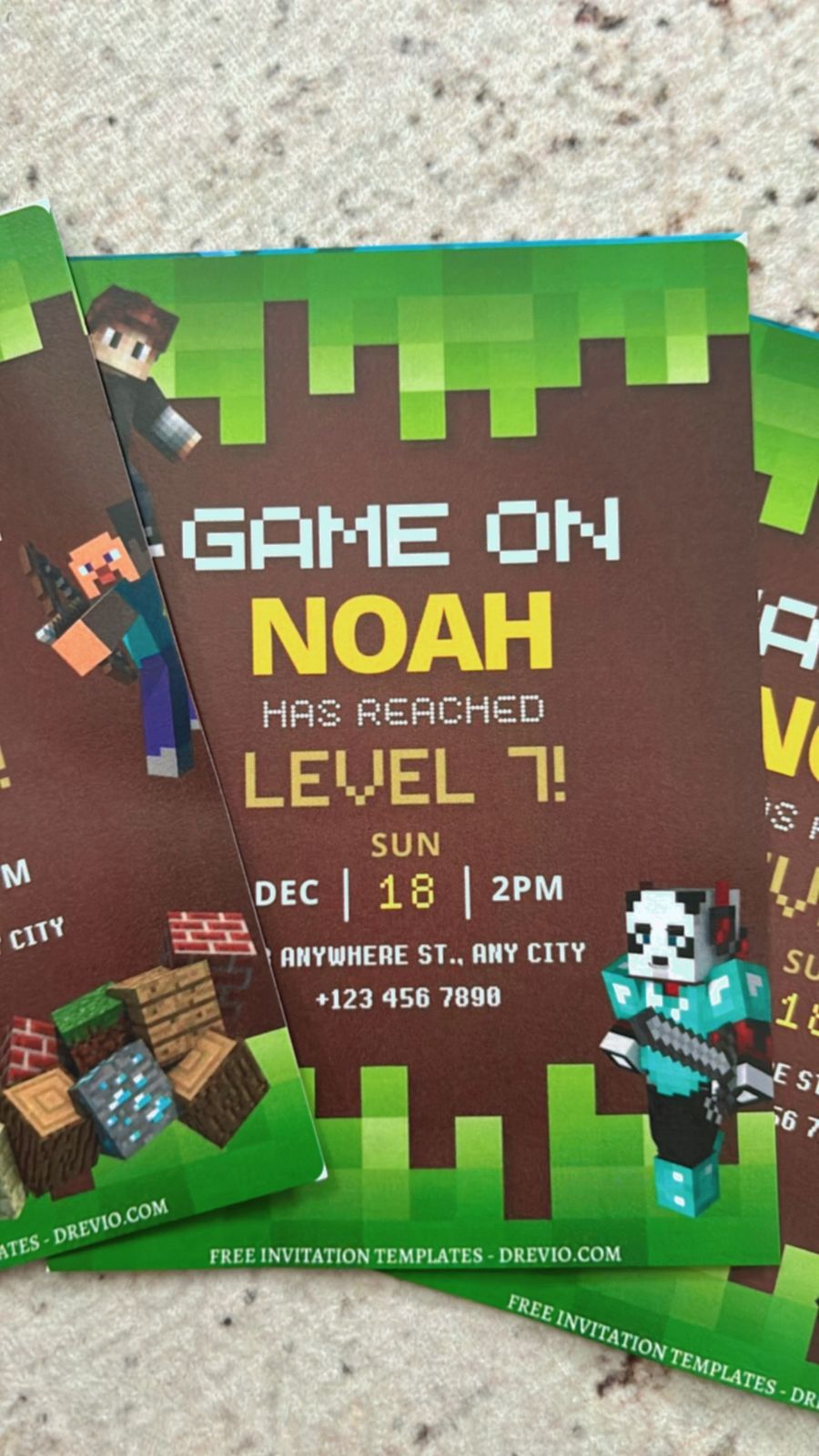 Close-up of a Minecraft-themed birthday invitation with green pixel blocks and creeper design