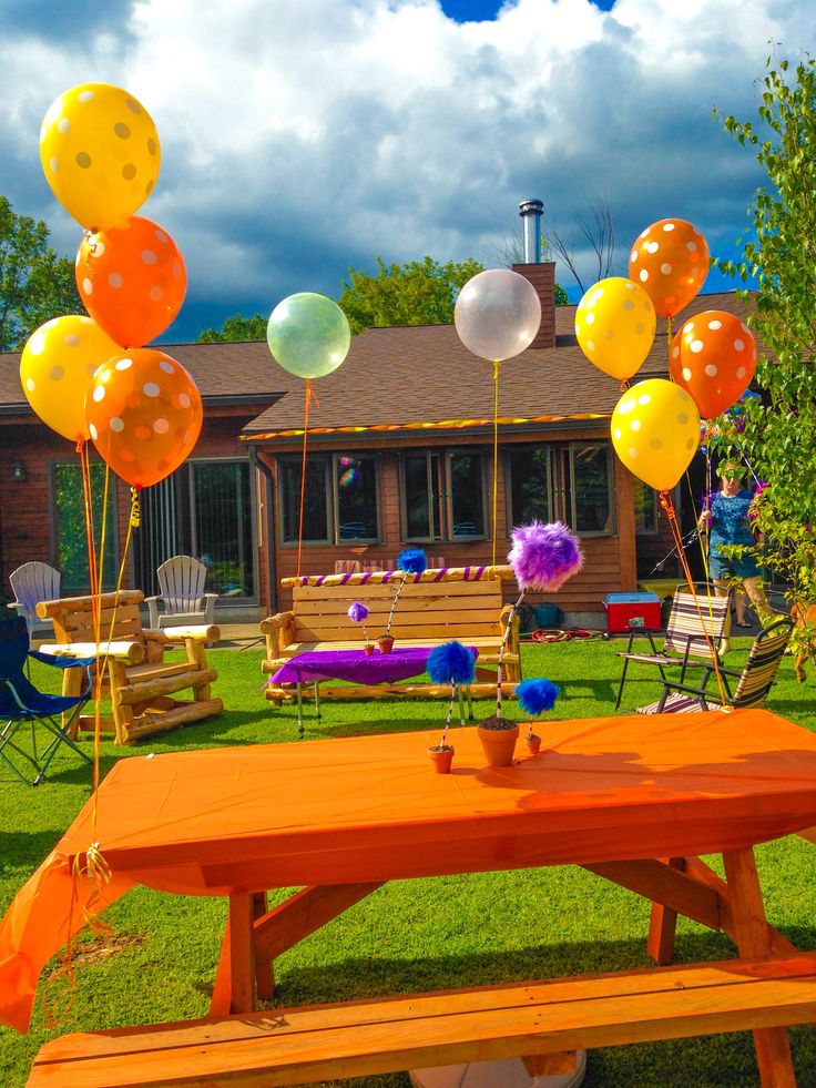 Editable Lorax birthday invitation surrounded by colorful Truffula trees, fluffy tufts, butterflies, and whimsical woodland details