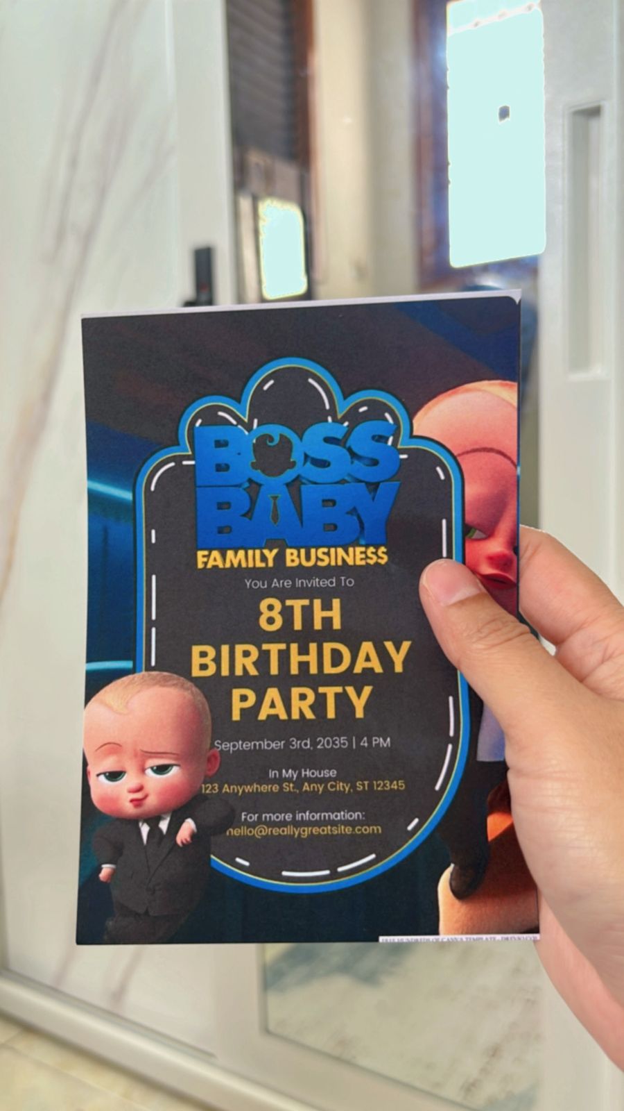 Themed invitation design emphasizing Boss Baby suit-and-tie motif, layered text hierarchy, and clean white space with navy accents