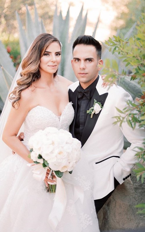Happy Couple In White Ball Gown And Black Tuxedo