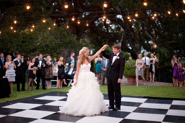 Happy Couple Dancing On Checkered Dance Floor