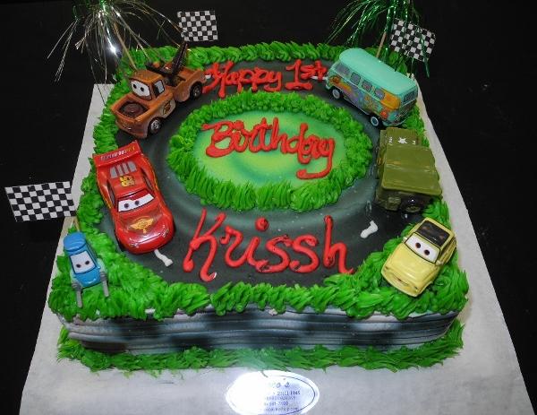 Birthday Sheet Cake With Race Track Design and Disney Cars Character Figurines