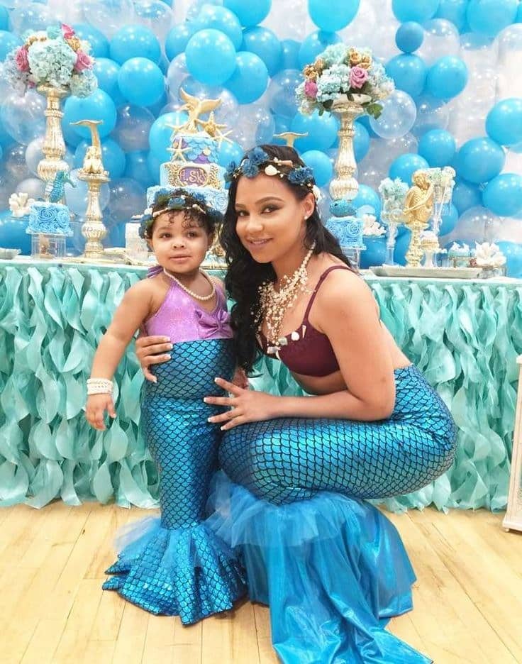 mom and her daughter dressed up as beautiful mermaids