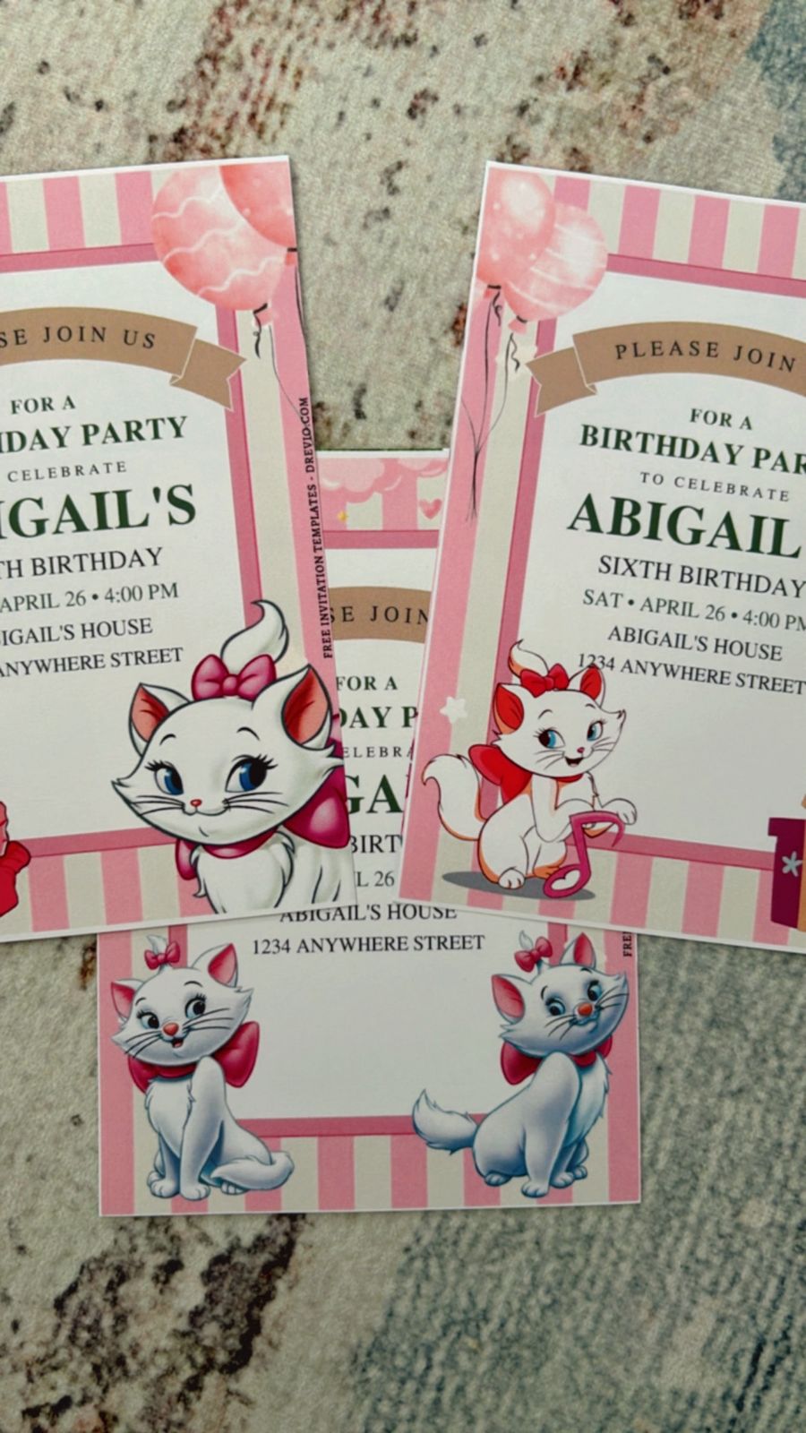 Elegant Marie the Cat invitation layout with white and gold accents, ribbon bows, and minimal chic style