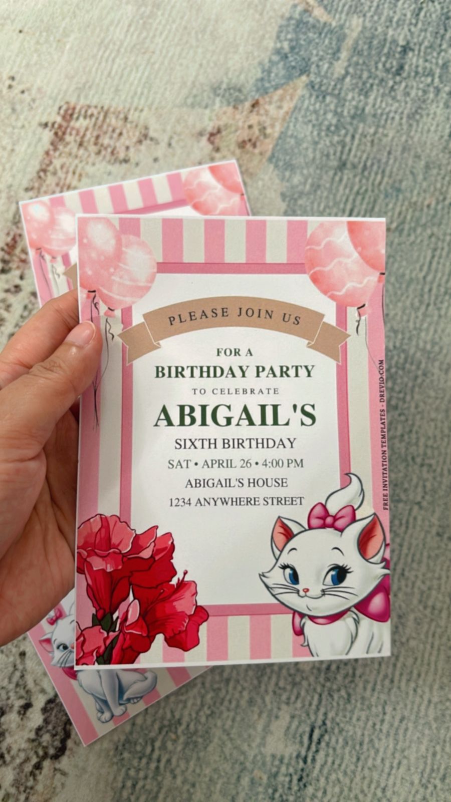 Marie the Cat birthday invitation with pink bows, gold sparkles, and soft blush background theme