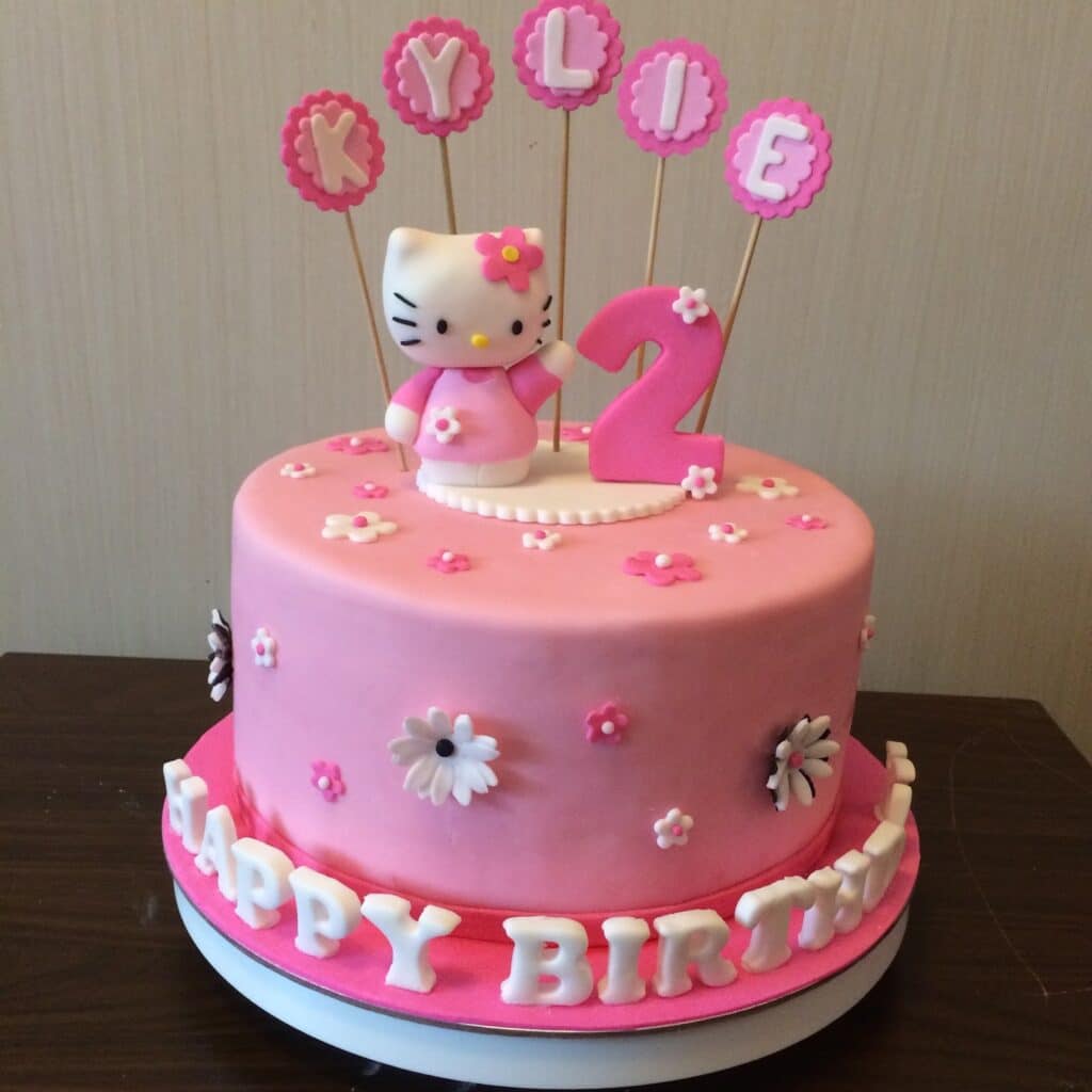 Hello Kitty Birthday Cake With Pink Fondant, Edible Happy Birthday Letters, Edible Floral made of sugar, and Hello Kitty Cake Topper