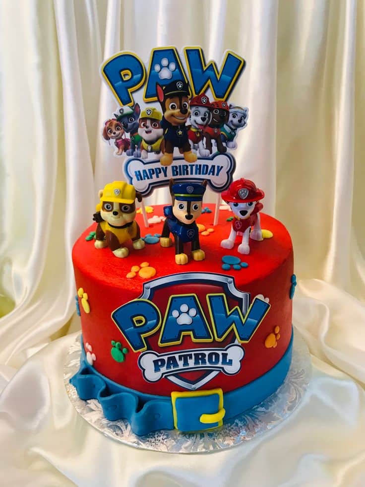 PAW Patrol Cake with red frosting and edible PAW Patrol Badge and Figurines