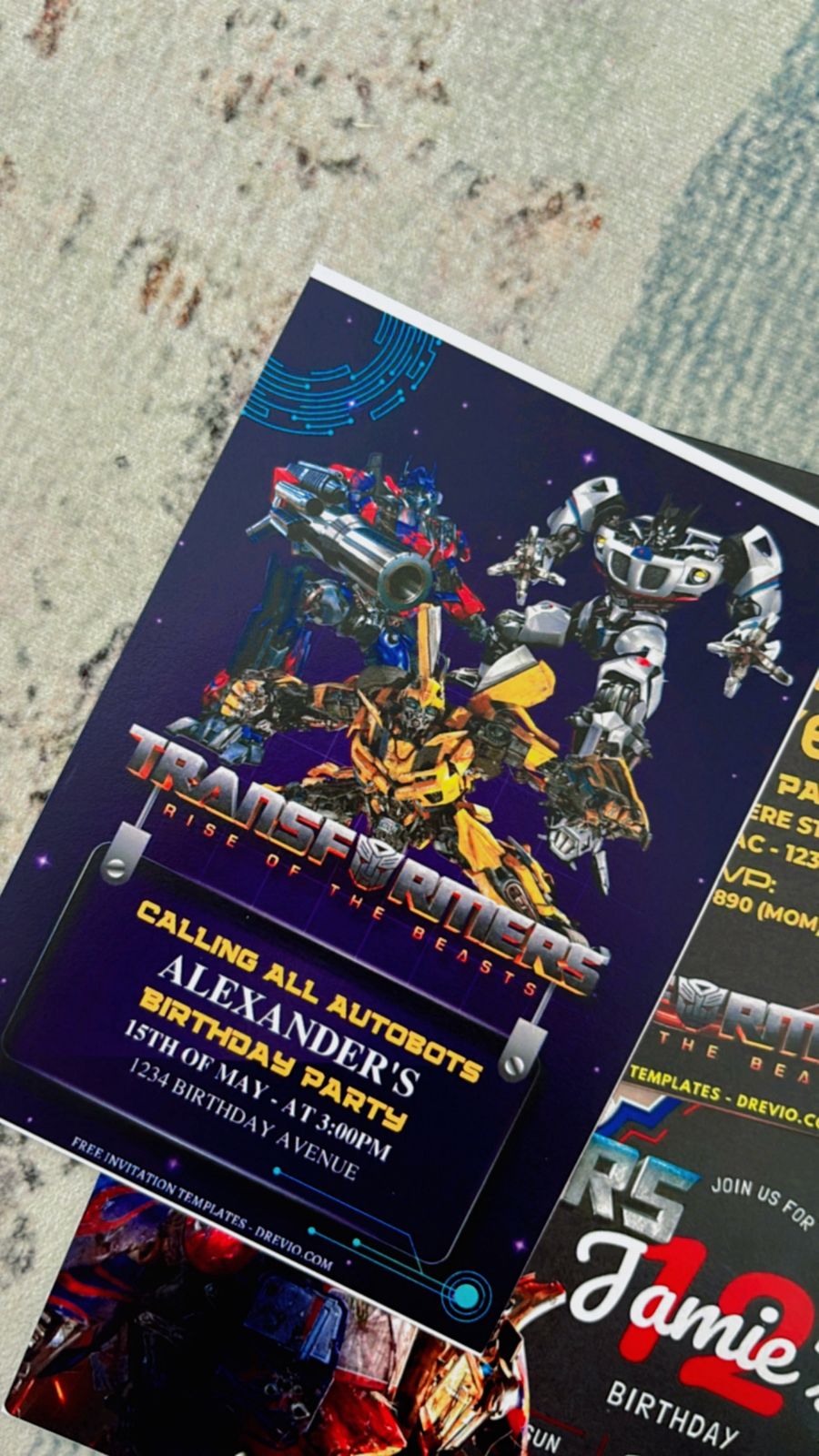Close-up of movie-style Transformer birthday invite with Optimus Prime-inspired graphics, circular emphasis on robot face icons, and explosive energy effects