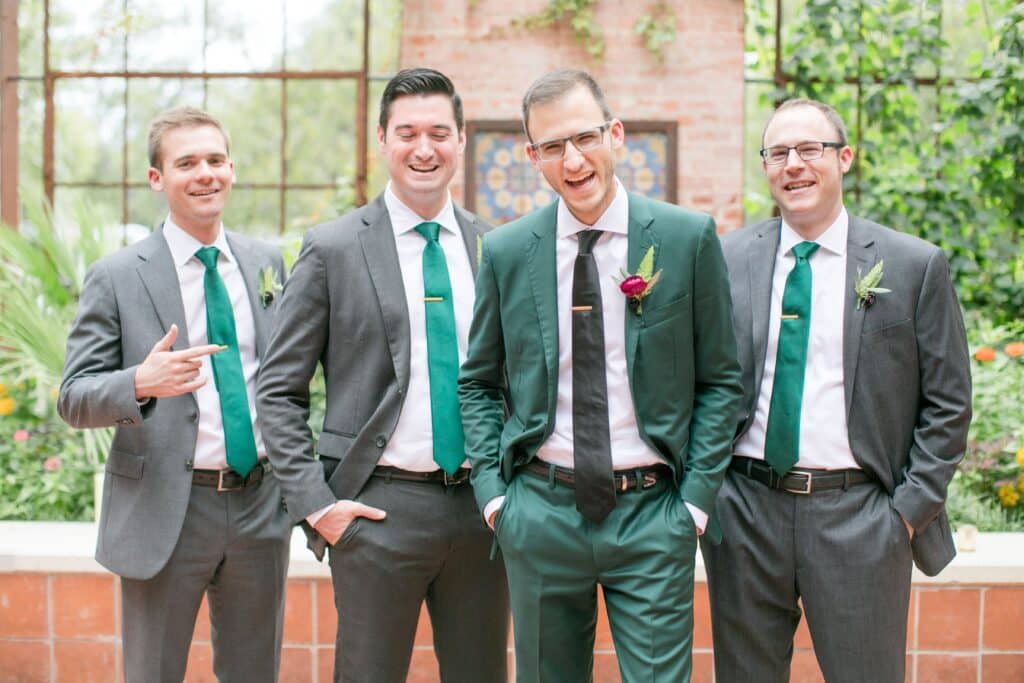 Groom in Emerald Green & Groomsmen in Grey Suits