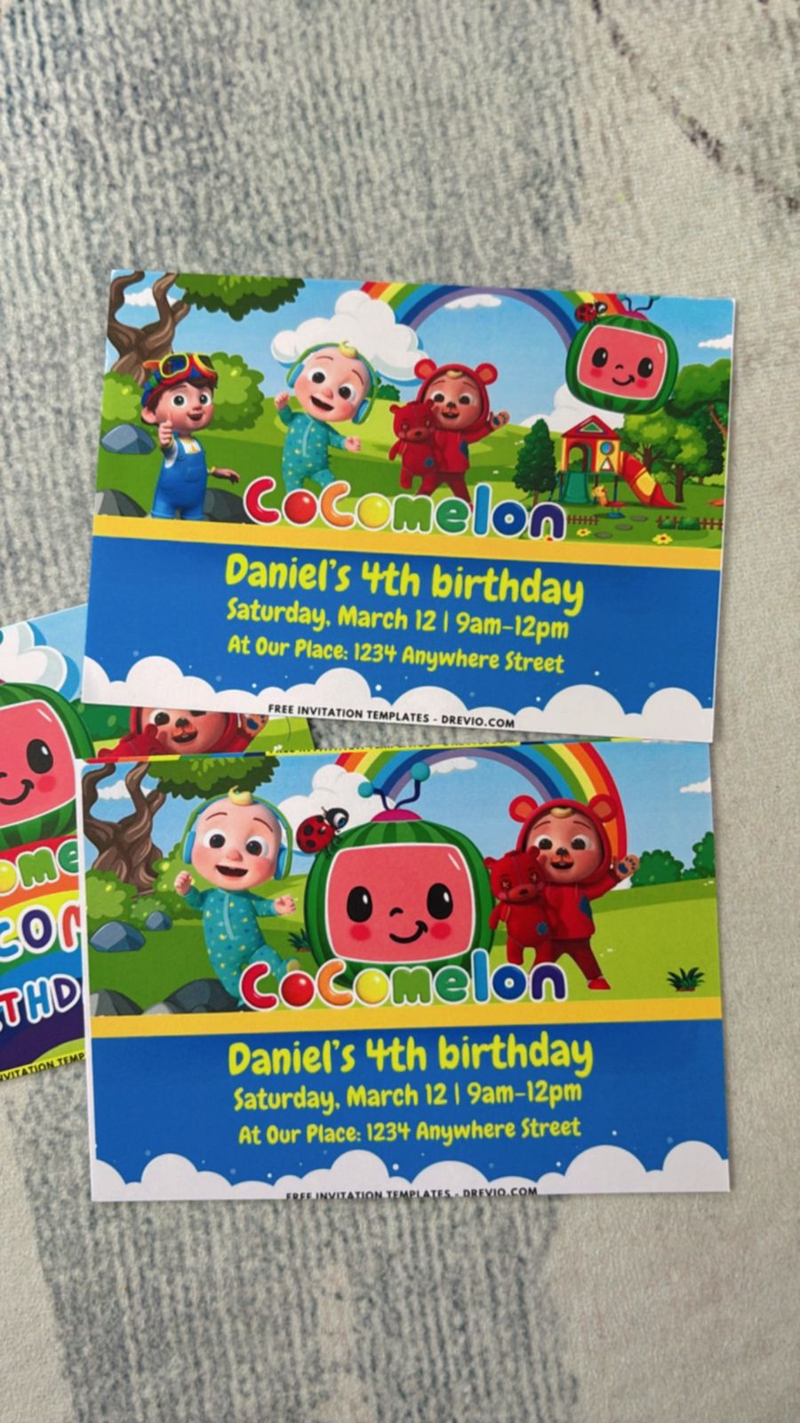 Cocomelon-themed invite with school bus, trees, clouds, and cartoon animals arranged in cheerful scene
