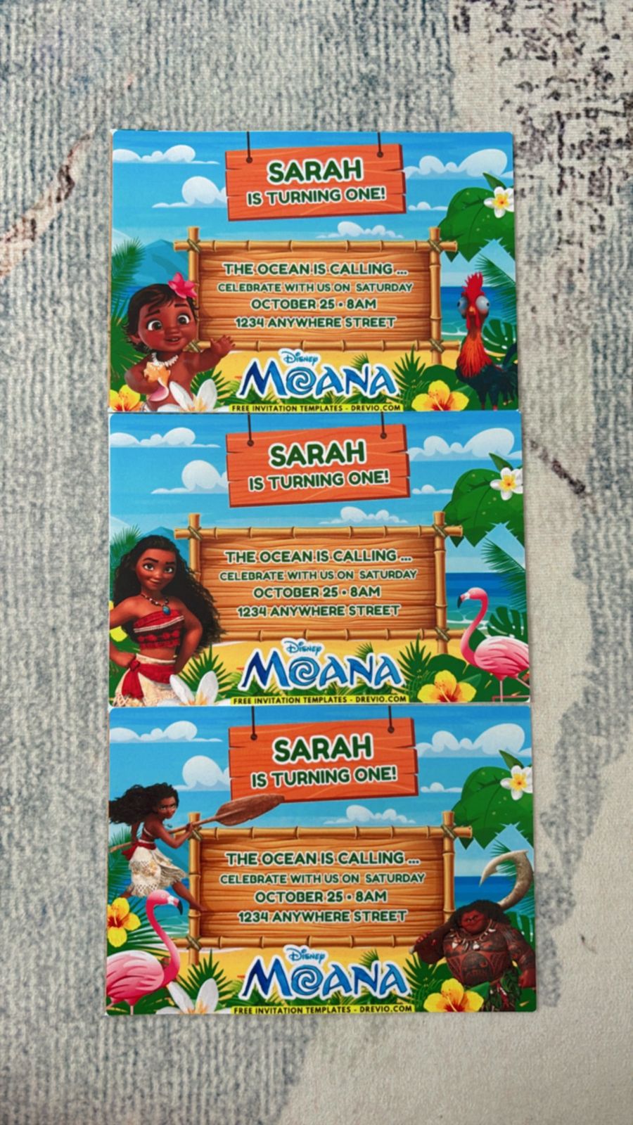 Kids Moana party invite with ocean blue waves, sand textures, and Heart of Te Fiti inspired green detail