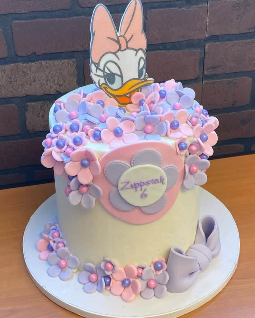 Adorable Daisy Duck Birthday Cake Topper with floral icing