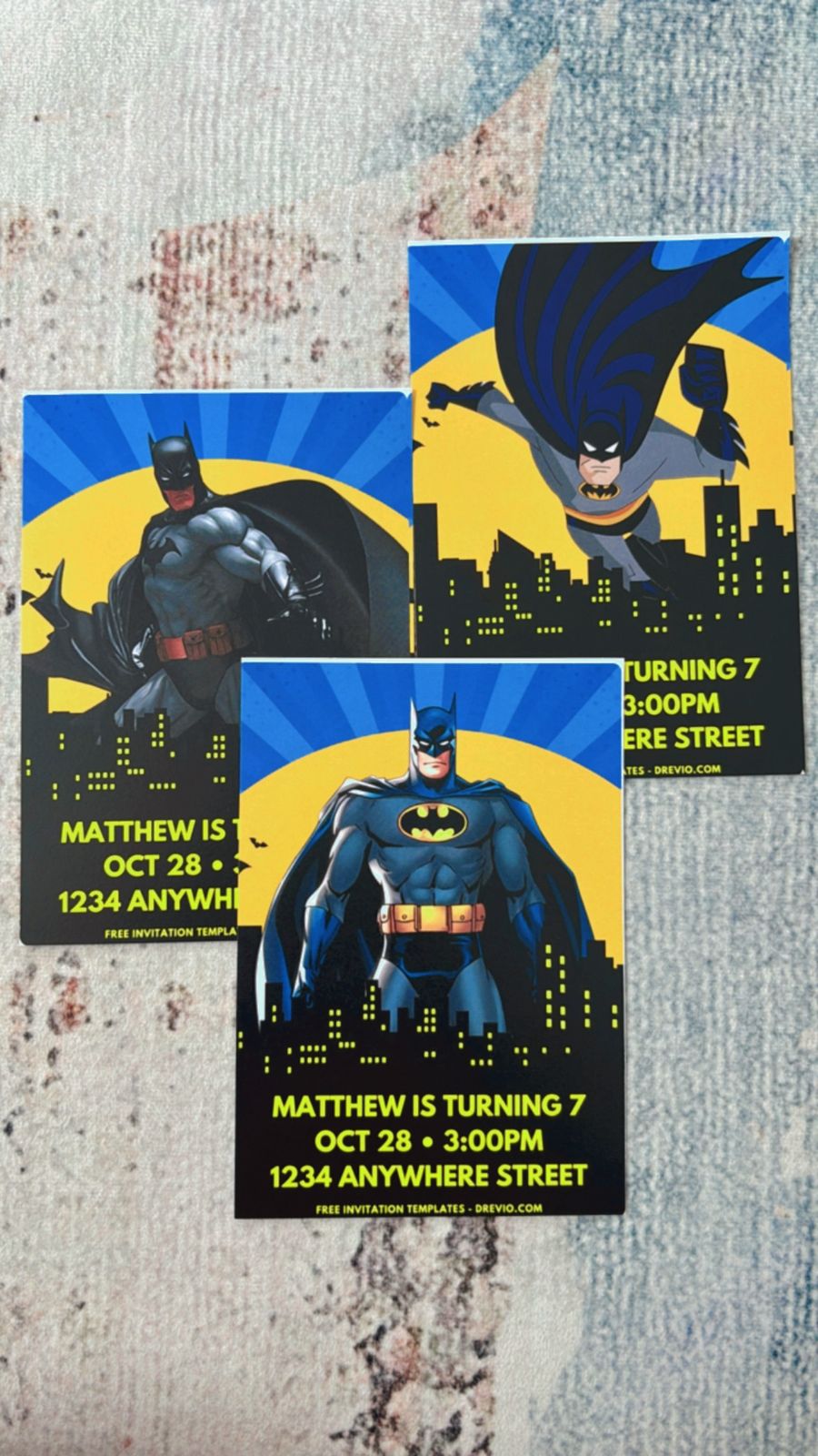 Kids Batman party invite featuring comic panels, action words, city backdrop, and superhero-themed graphic elements