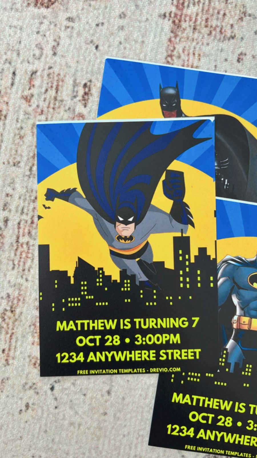 Gotham skyline Batman birthday invitation with glowing bat signal, dark city buildings, and bold comic-style typography