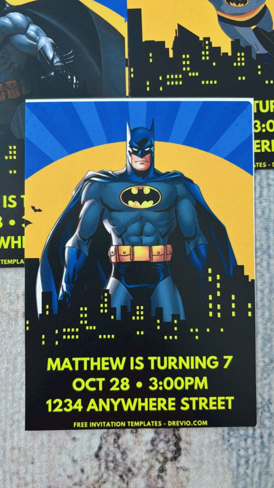 Batman birthday invitation design with black and yellow theme, bat icons, spotlight effect, and minimal Gotham aesthetic