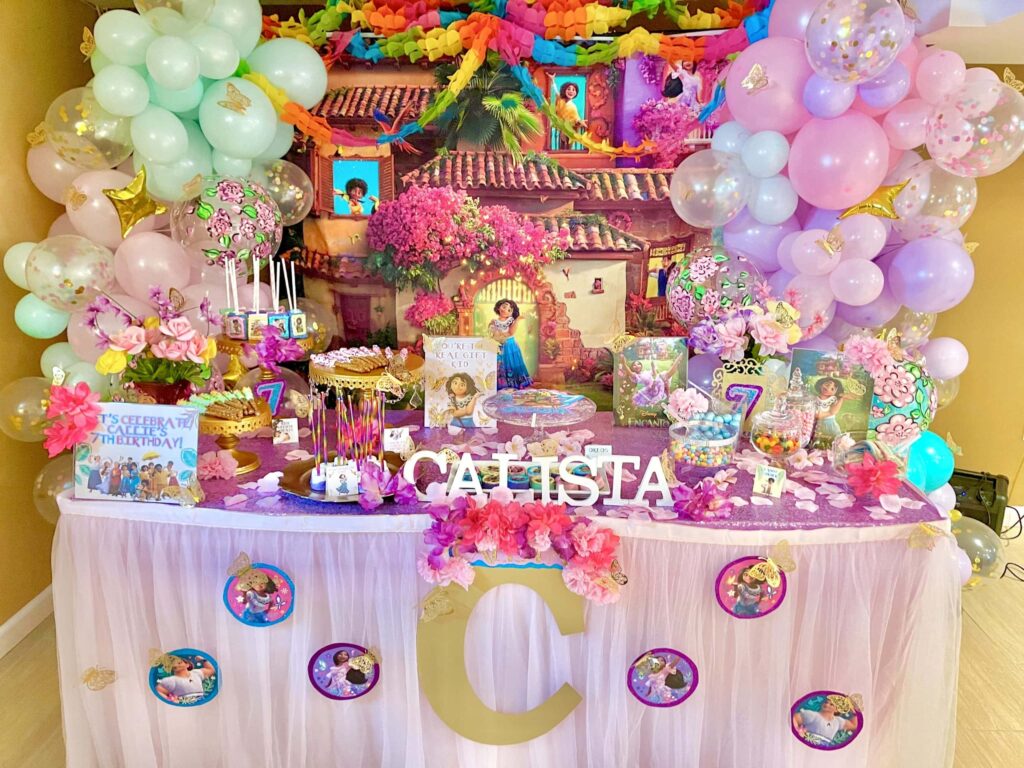 Festive Disney Encanto themed Birthday Party with colorful papel picado garland
