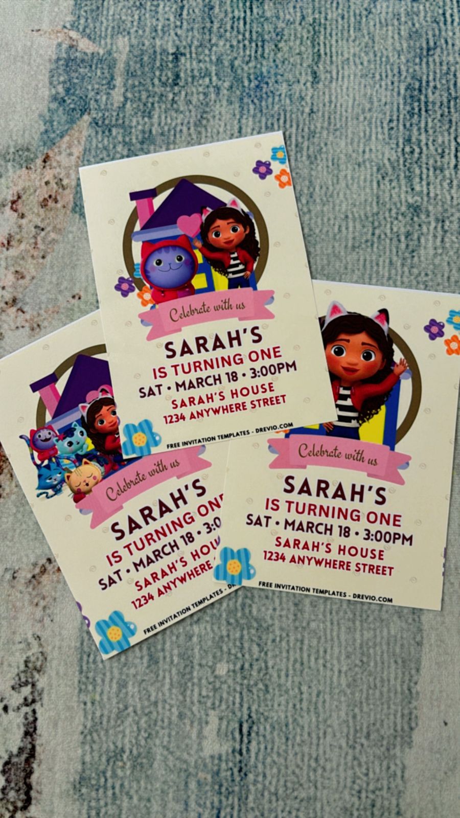 Bright Gabby Dollhouse party invitation with multiple characters, paw print borders, and colorful mini room accents