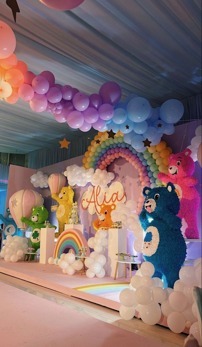 Rainbow Care Bears birthday invitation with dreamy clouds, smiling sun, floating hearts, and magical sparkle elements