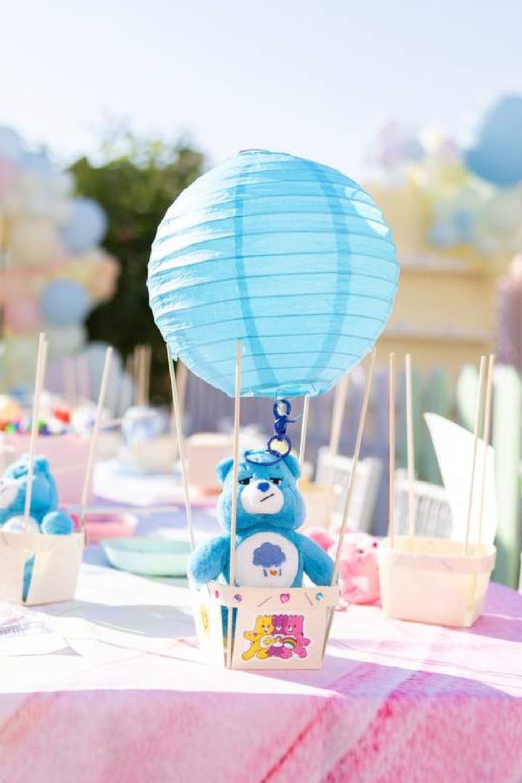 Cute Care Bears invitation Canva template with pastel clouds, rainbow arch, sparkling stars, and heart-shaped decorations