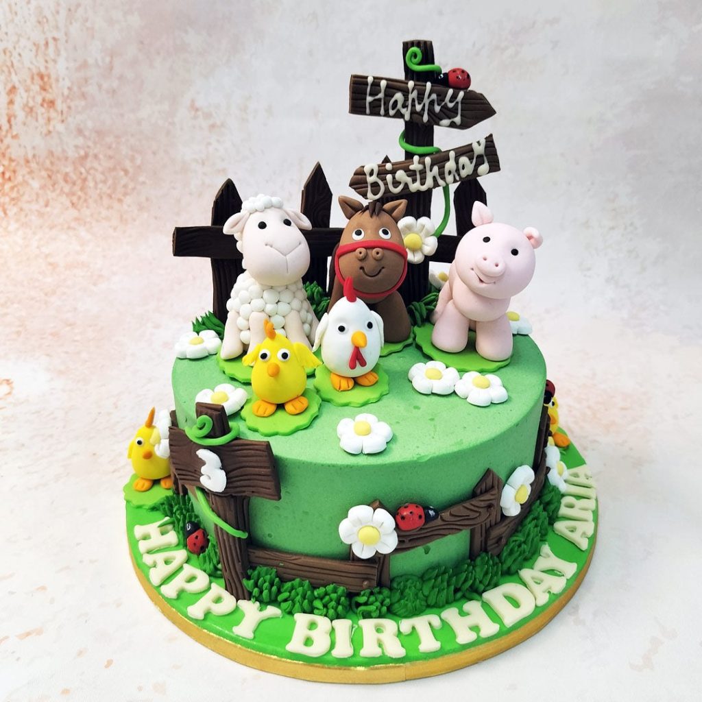 Farm Animals Theme Cake with green frosting and edible fondant Farm Animal figurines