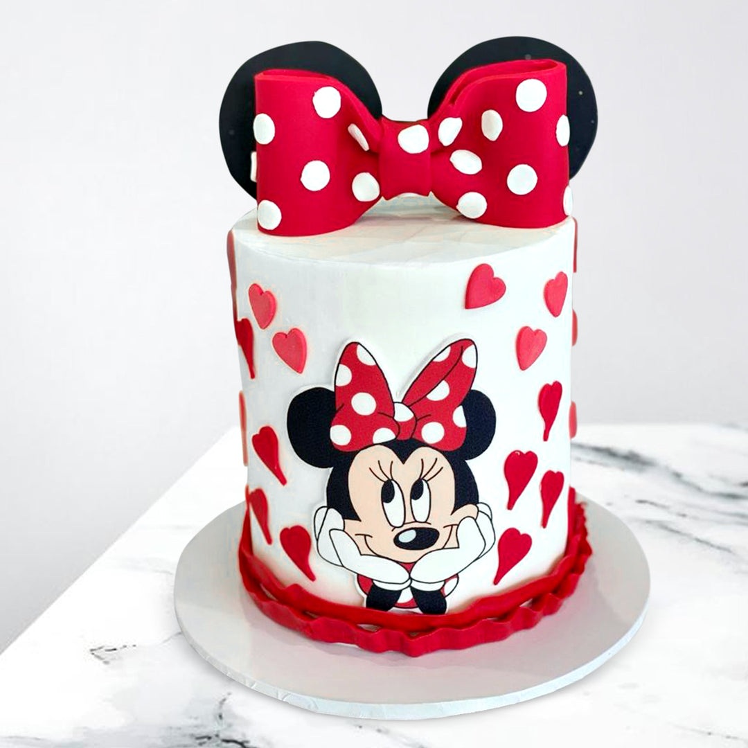 Adorable Minnie Mouse Cake with pink fondant, pink bow and cute Minnie Mouse topper