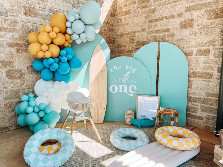 Backyard The Big One - Surf First Birthday Party decor with Surf Board and custom balloon clusters