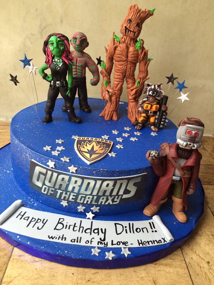 deep navy guardians of galaxy birthday cake with Groot Rocket Raccoon Drax and Star Lord figurines